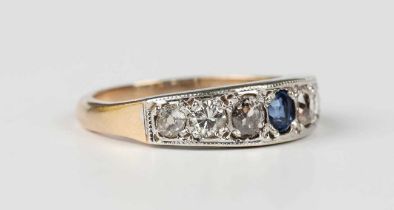 A gold, sapphire and diamond ring, mounted with an oval cut sapphire between six variously cut