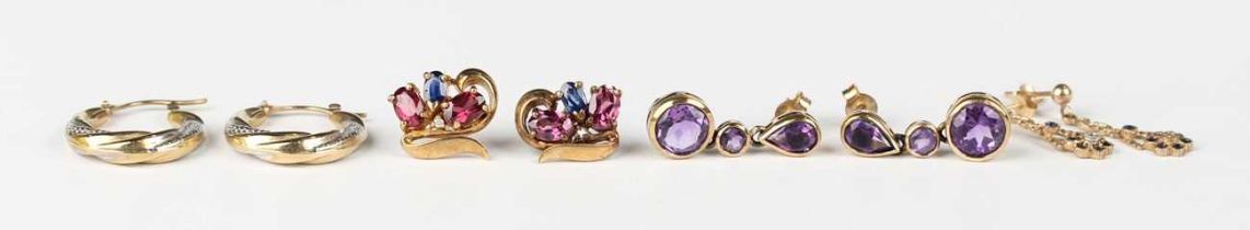 A pair of gold and amethyst three stone earrings, detailed ‘375’, length 2.4cm, a pair of 9ct