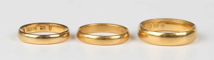A late Victorian 22ct gold wedding ring, London 1894, ring size approx P, and two further 22ct