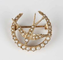An Edwardian gold, seed pearl and diamond brooch, designed as a swallow within a crescent, unmarked,