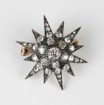 A late Victorian silver set and diamond brooch designed as a starburst, mounted with cushion and