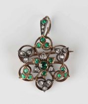 A late Victorian gold backed and silver set, diamond, emerald and green gem set pendant brooch,