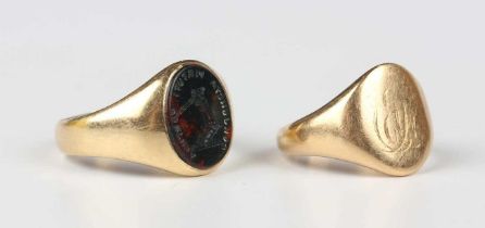 A gold and bloodstone oval signet ring, engraved with an arm holding a sword between motto ‘