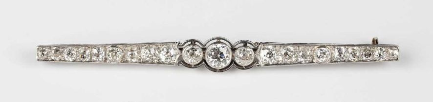 A diamond bar brooch, 1920s, mounted with a graduated row of old cut diamonds, the principal three
