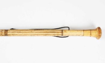 A 19th century scrimshaw whalebone walking cane, the shaft carved with sections of reeding and