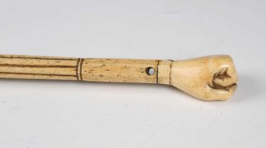 A 19th century scrimshaw whalebone walking cane, the shaft divided into sections of reeded, spiral
