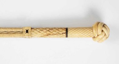 A 19th century scrimshaw whalebone walking cane, the shaft carved with an upper section of