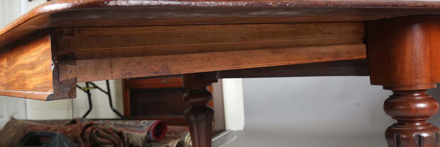 A large early Victorian mahogany pull-out extending dining table, the rectangular top with three - Image 6 of 7