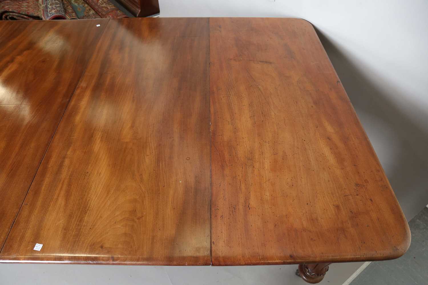 A large early Victorian mahogany pull-out extending dining table, the rectangular top with three - Image 4 of 7