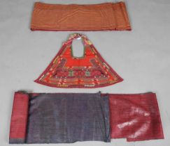 A Karakalpak girl's bib, Uzbekistan, finely worked with geometric bands, width 70cm, together with a