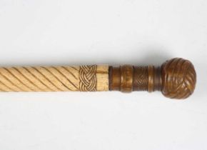 A 19th century scrimshaw whalebone walking cane, the shaft carved with spiral reeding divided by