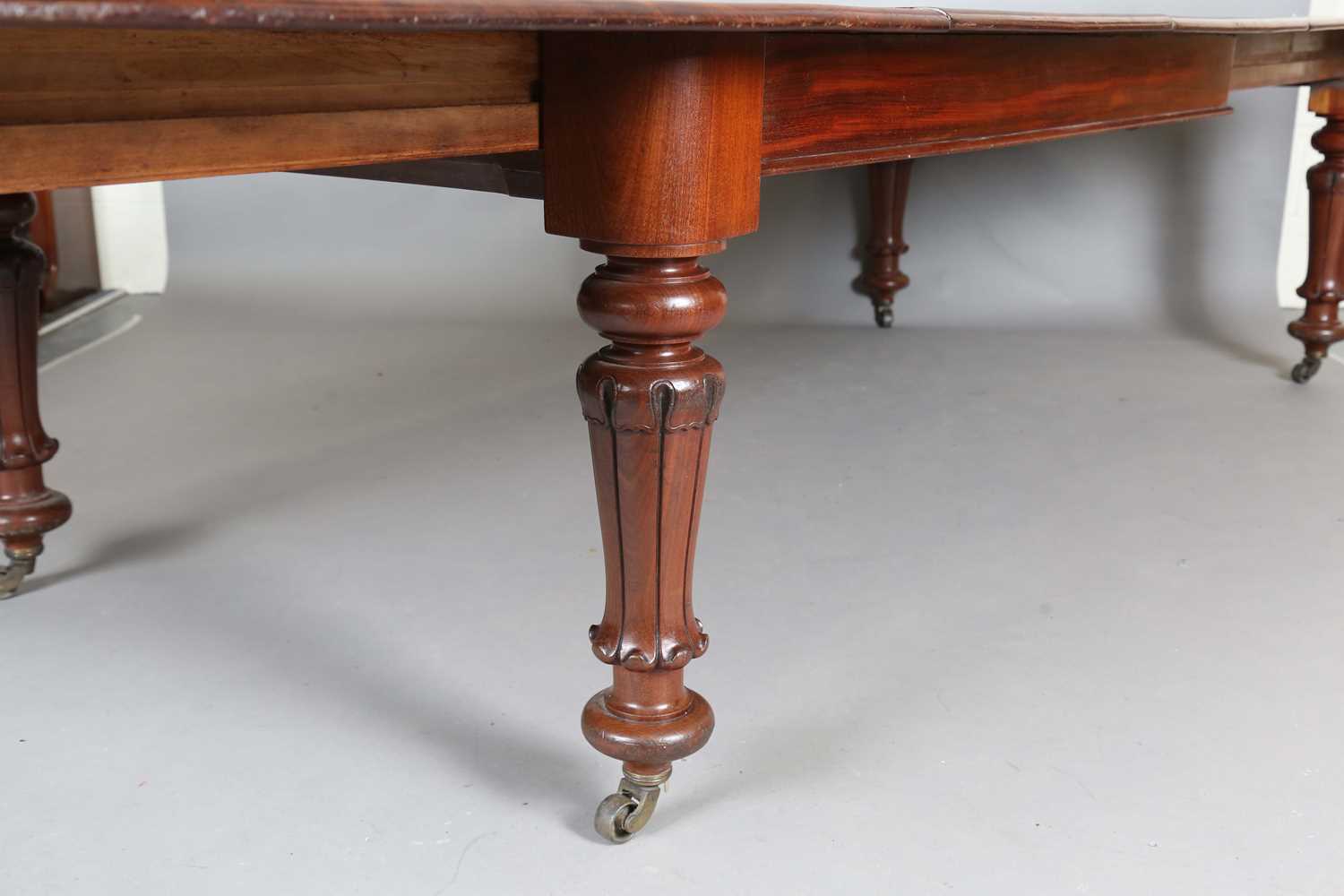 A large early Victorian mahogany pull-out extending dining table, the rectangular top with three - Image 5 of 7