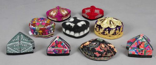 A group of nine embroidered ethnic hats, including three folding Uzbek examples. Note: from the