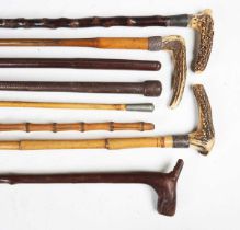 A group of various 19th century and later walking and swagger sticks, three fitted with antler