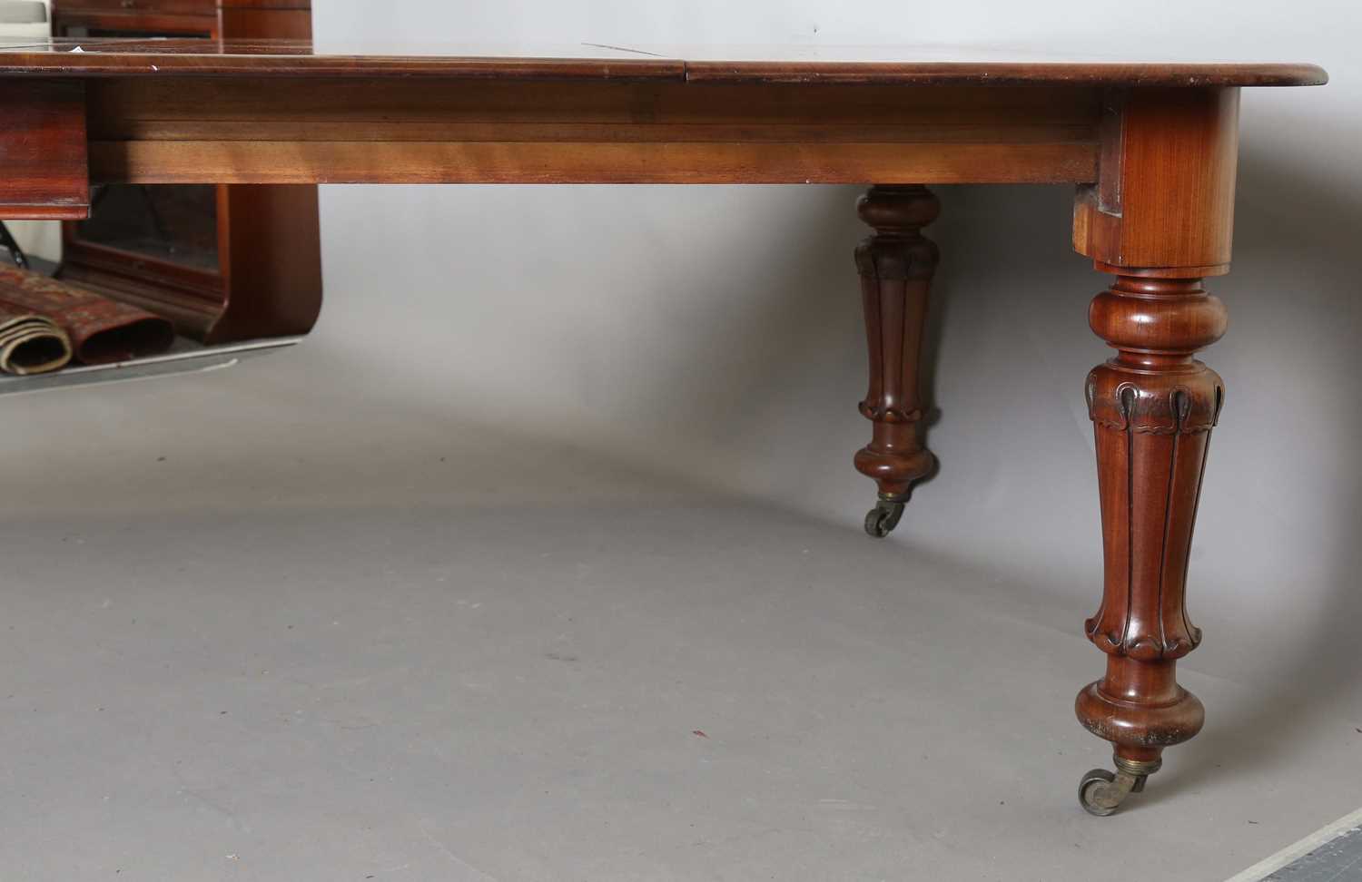 A large early Victorian mahogany pull-out extending dining table, the rectangular top with three - Image 7 of 7