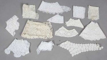 A selection of 19th century lacework, including collars, headpieces, a pair of cuffs and a deep