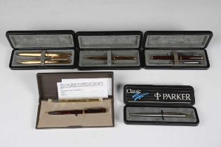 A group of fountain and ballpoint pens, including a Parker gilt metal fountain pen and matching
