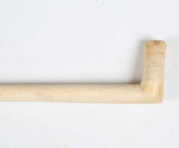A 19th century scrimshaw whalebone walking stick with simple carved handle, length 91cm.