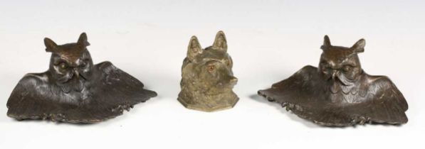An early 20th century cast bronze inkwell in the form of a dog's head with inset glass eyes,