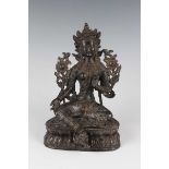 A Sino-Tibetan brown patinated bronze figure of Tara, probably late Qing dynasty, modelled seated in