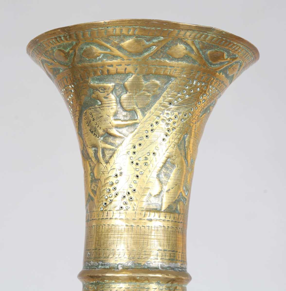 An Islamic brass floor lamp, circa 1900, the flared surmount and cylindrical column decorated with - Image 2 of 24