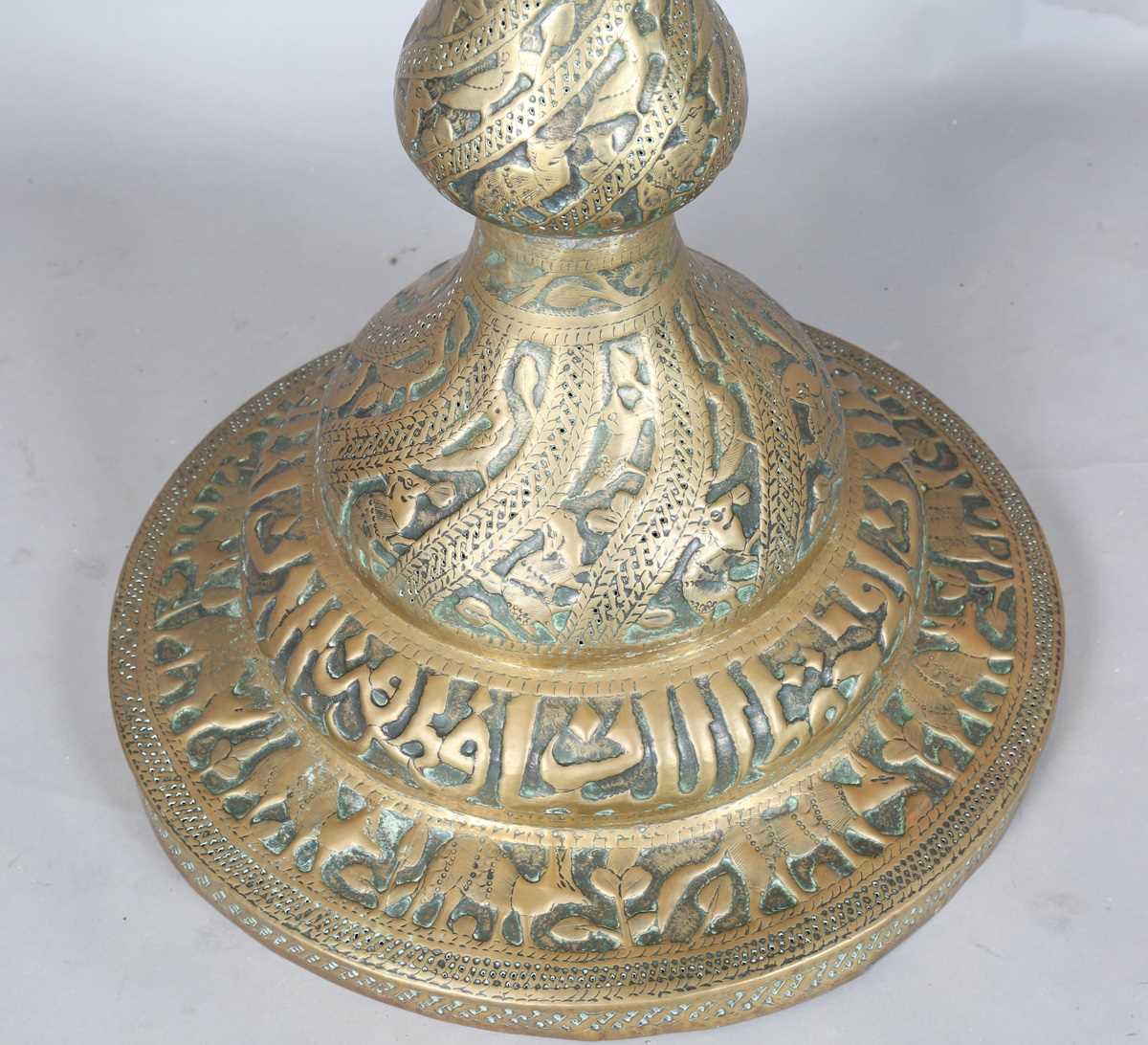 An Islamic brass floor lamp, circa 1900, the flared surmount and cylindrical column decorated with - Image 13 of 24