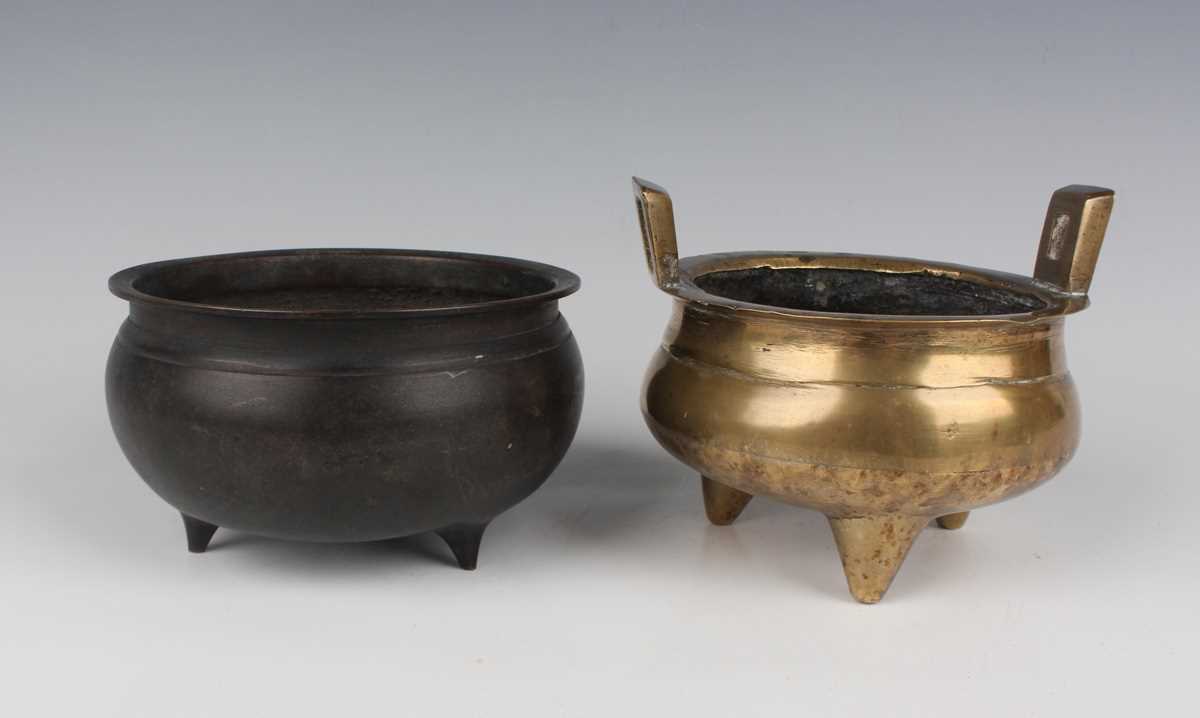 A Chinese brown patinated bronze tripod censer, Qing dynasty, of low-bellied circular form on