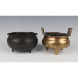 A Chinese brown patinated bronze tripod censer, Qing dynasty, of low-bellied circular form on