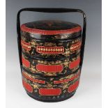 A Straits Chinese black lacquer and red woven cane three-tier wedding basket and cover, late Qing