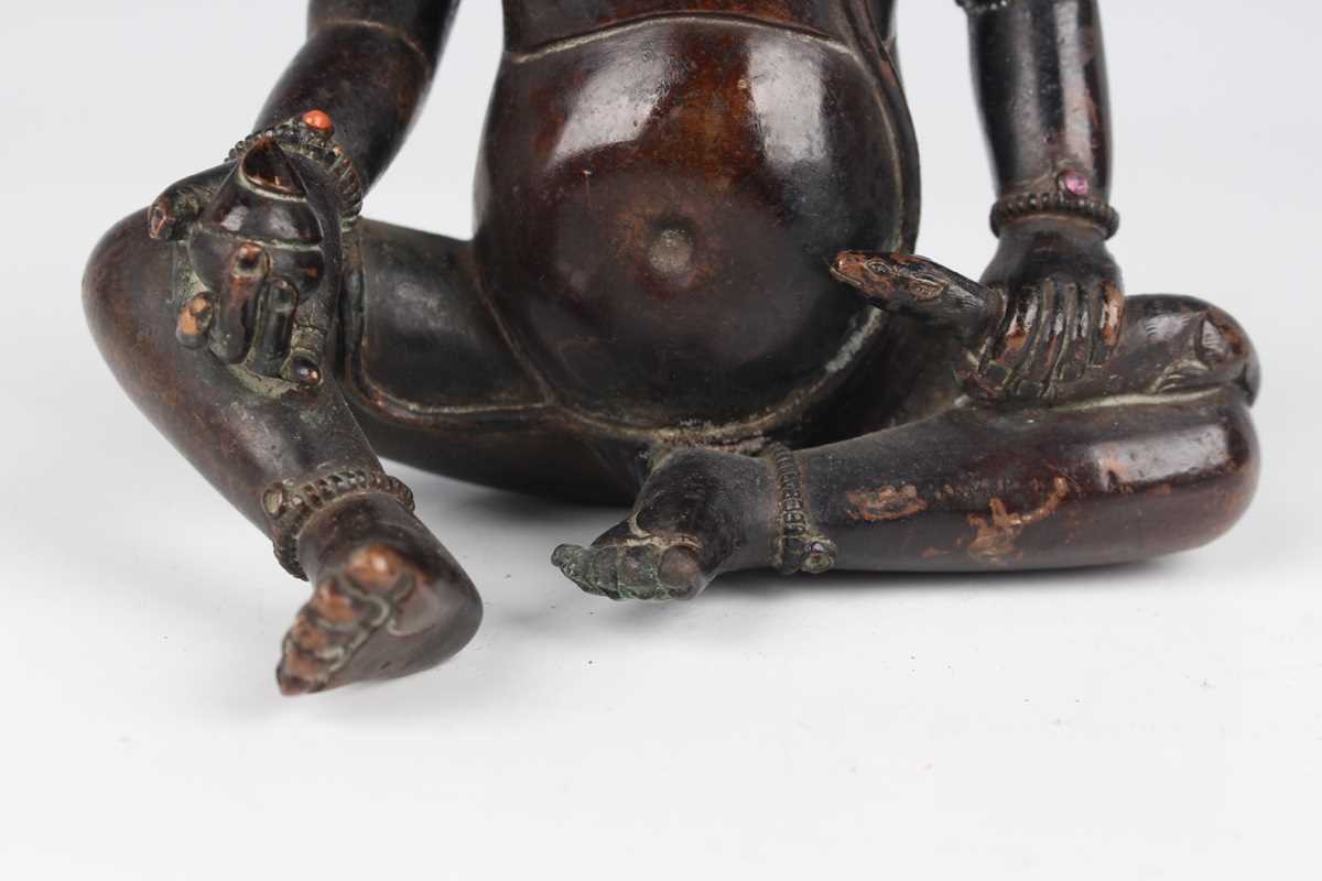 A Sino-Tibetan brown patinated copper alloy/bronze figure of Jambhala, late Qing dynasty, with - Image 4 of 8