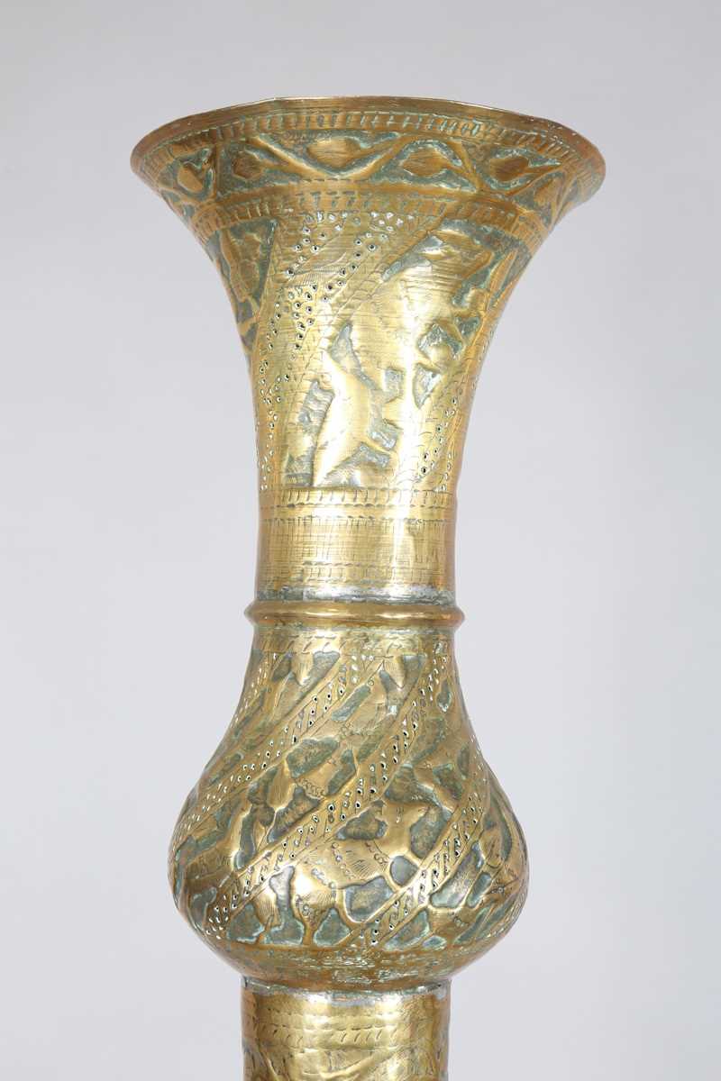 An Islamic brass floor lamp, circa 1900, the flared surmount and cylindrical column decorated with - Image 20 of 24