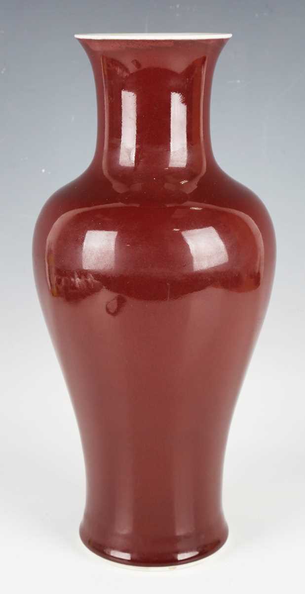 A Chinese sang-de-boeuf glazed porcelain vase, mark of Qianlong but modern, of baluster form with