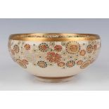 A Japanese Satsuma earthenware circular bowl, Meiji period, the exterior enamelled and gilt with a