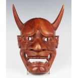 A Japanese carved wood noh mask of Hannya by Sukemasa, with finely carved and pierced facial details