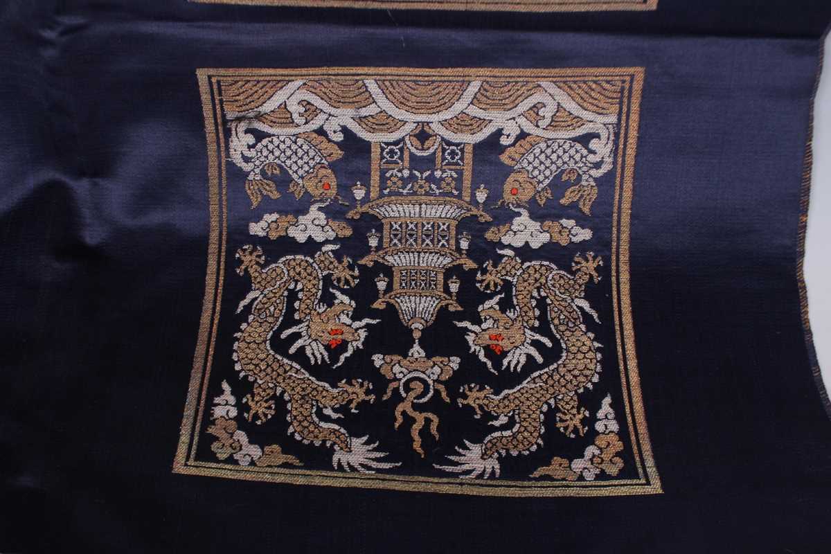 A Chinese blue silk embroidered rectangular panel, 20th century, worked with eight matching rank - Image 24 of 70