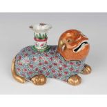 A Chinese famille rose porcelain jostick holder, mid-19th century, modelled as a recumbent puppy,