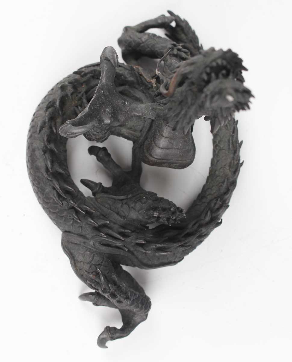 A Japanese cast bronze figure of a dragon, 20th century, modelled in a coiled pose holding a - Image 6 of 9