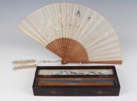 A Chinese Canton export sandalwood and silk folding fan, late 19th century, the guards carved with