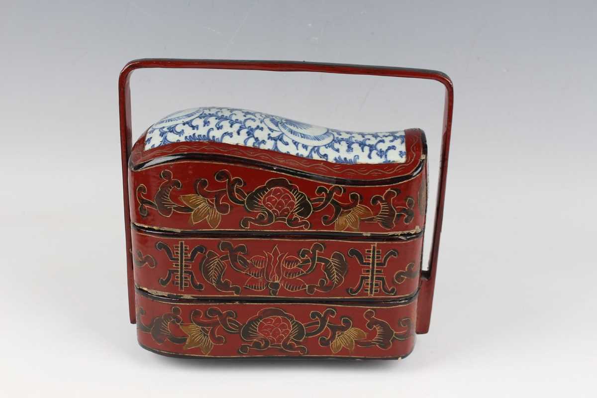 A Chinese red lacquer three-tier box with overhead handle, late 19th/early 20th century, decorated - Image 4 of 46