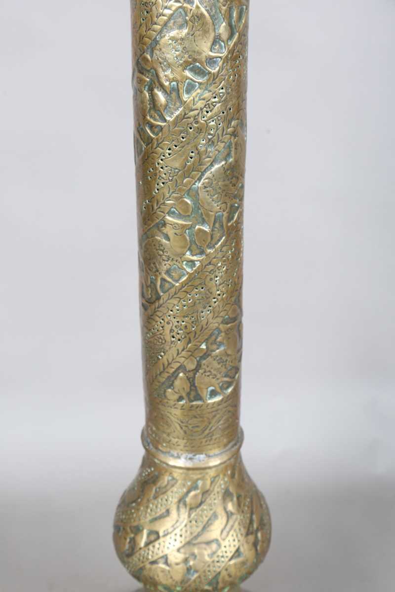 An Islamic brass floor lamp, circa 1900, the flared surmount and cylindrical column decorated with - Image 17 of 24