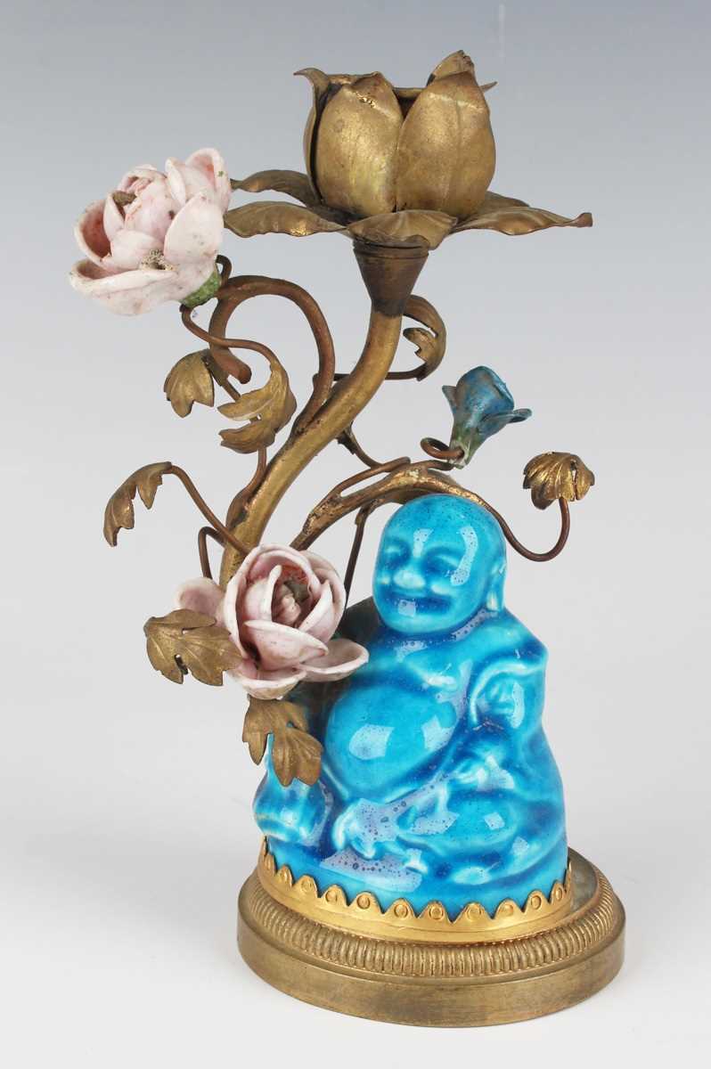 A Chinese turquoise glazed porcelain figure of Buddha, Qing dynasty, height 7cm, with gilt metal