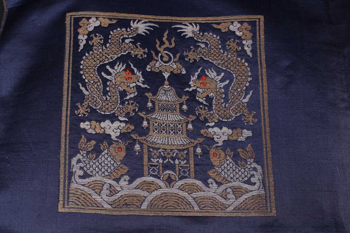 A Chinese blue silk embroidered rectangular panel, 20th century, worked with eight matching rank - Image 25 of 70