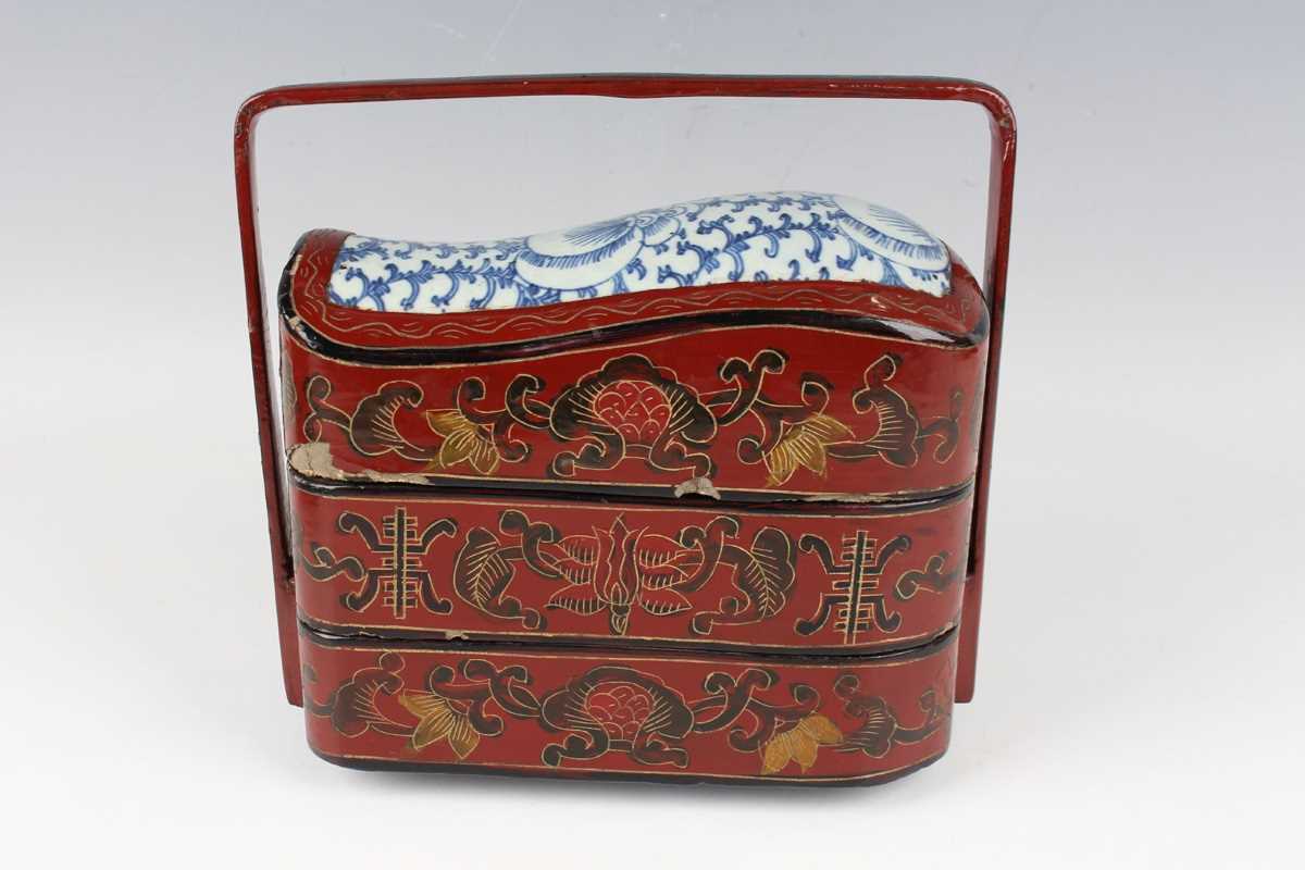 A Chinese red lacquer three-tier box with overhead handle, late 19th/early 20th century, decorated - Image 2 of 46