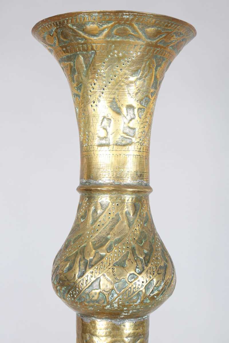 An Islamic brass floor lamp, circa 1900, the flared surmount and cylindrical column decorated with - Image 15 of 24