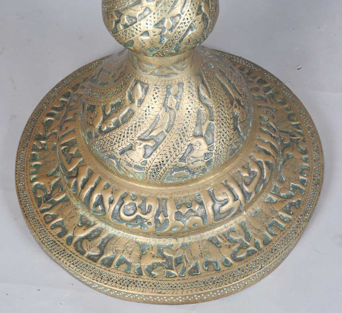 An Islamic brass floor lamp, circa 1900, the flared surmount and cylindrical column decorated with - Image 23 of 24