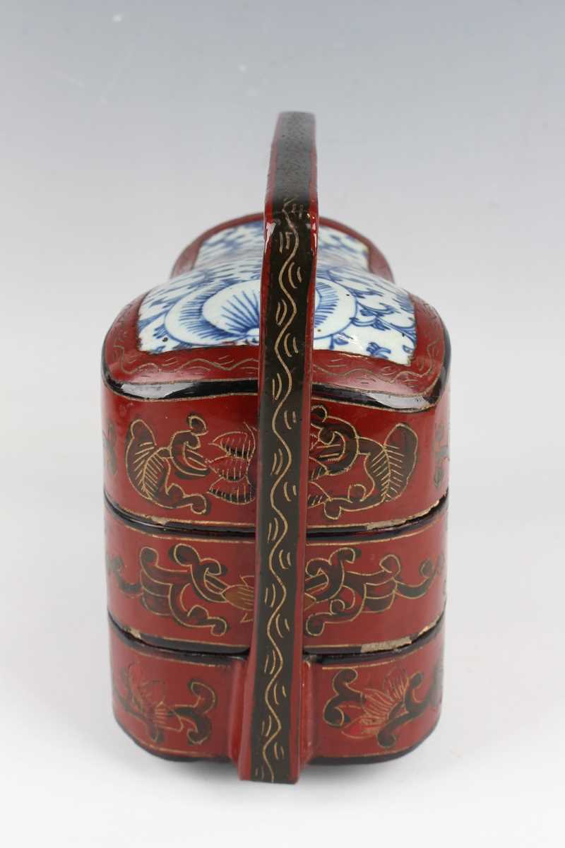 A Chinese red lacquer three-tier box with overhead handle, late 19th/early 20th century, decorated - Image 5 of 46