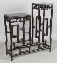 A Chinese hardwood asymmetrical stand, early 20th century, each rectangular panelled top with