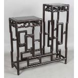 A Chinese hardwood asymmetrical stand, early 20th century, each rectangular panelled top with