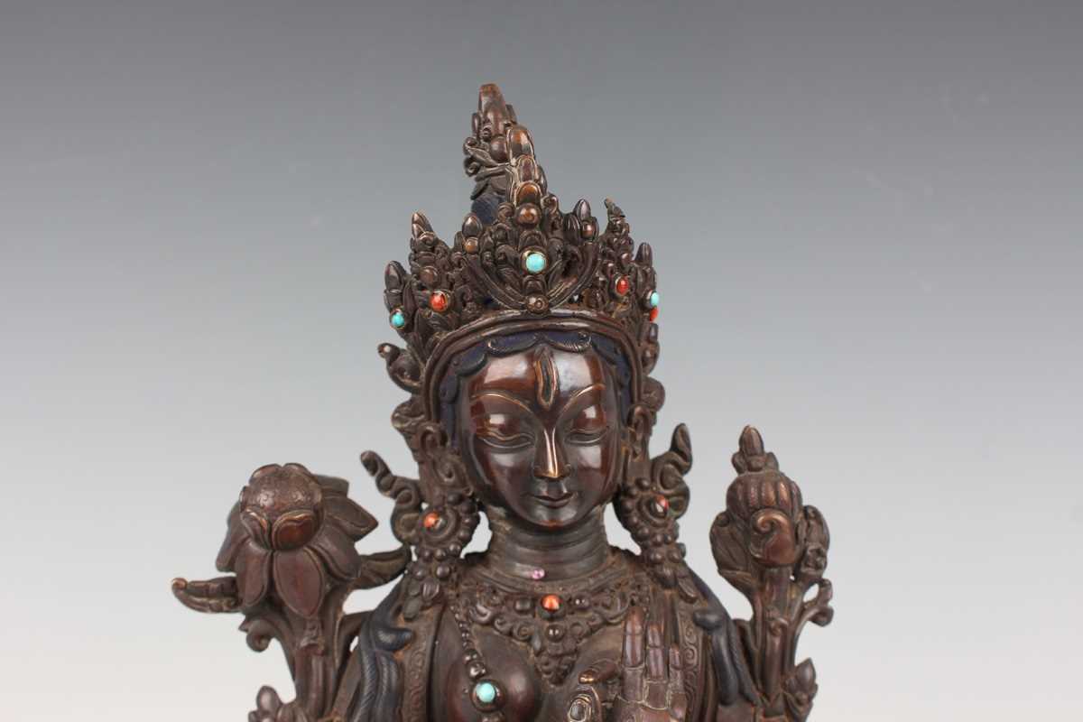 A Sino-Tibetan brown patinated copper alloy figure of Tara, 20th century, modelled seated in - Image 2 of 9