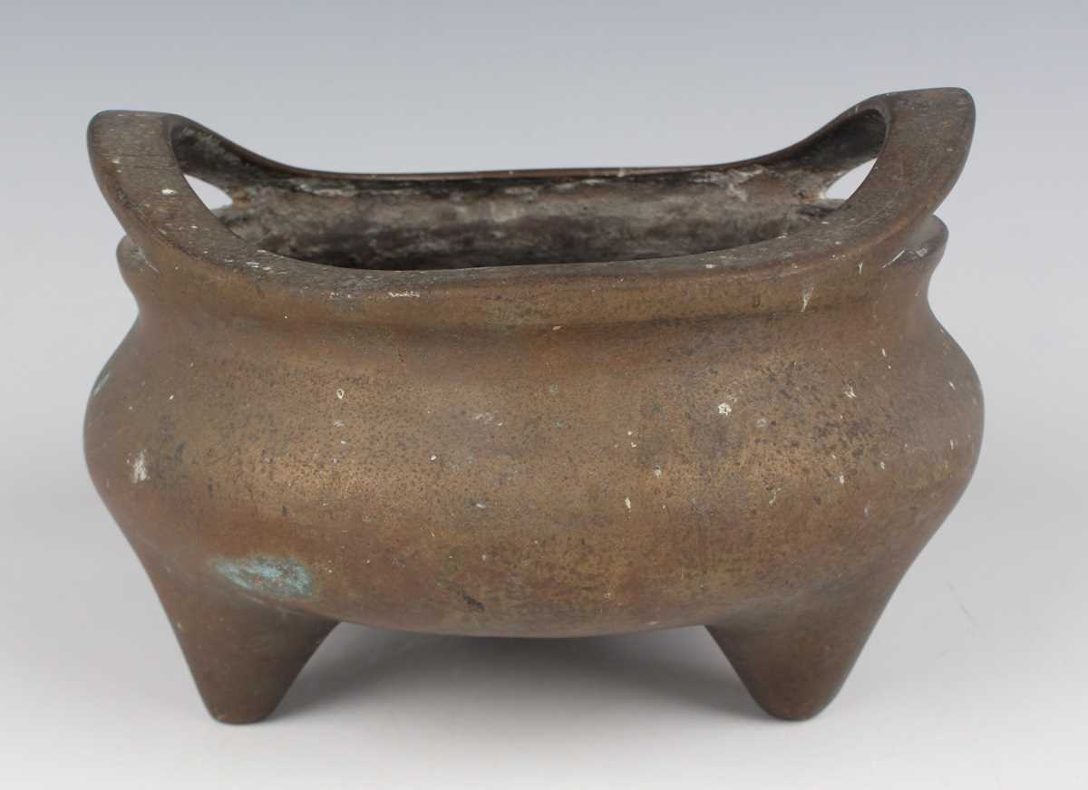 A Chinese bronze bombé censer, 19th/20th century, of low-bellied circular form with a pair of loop